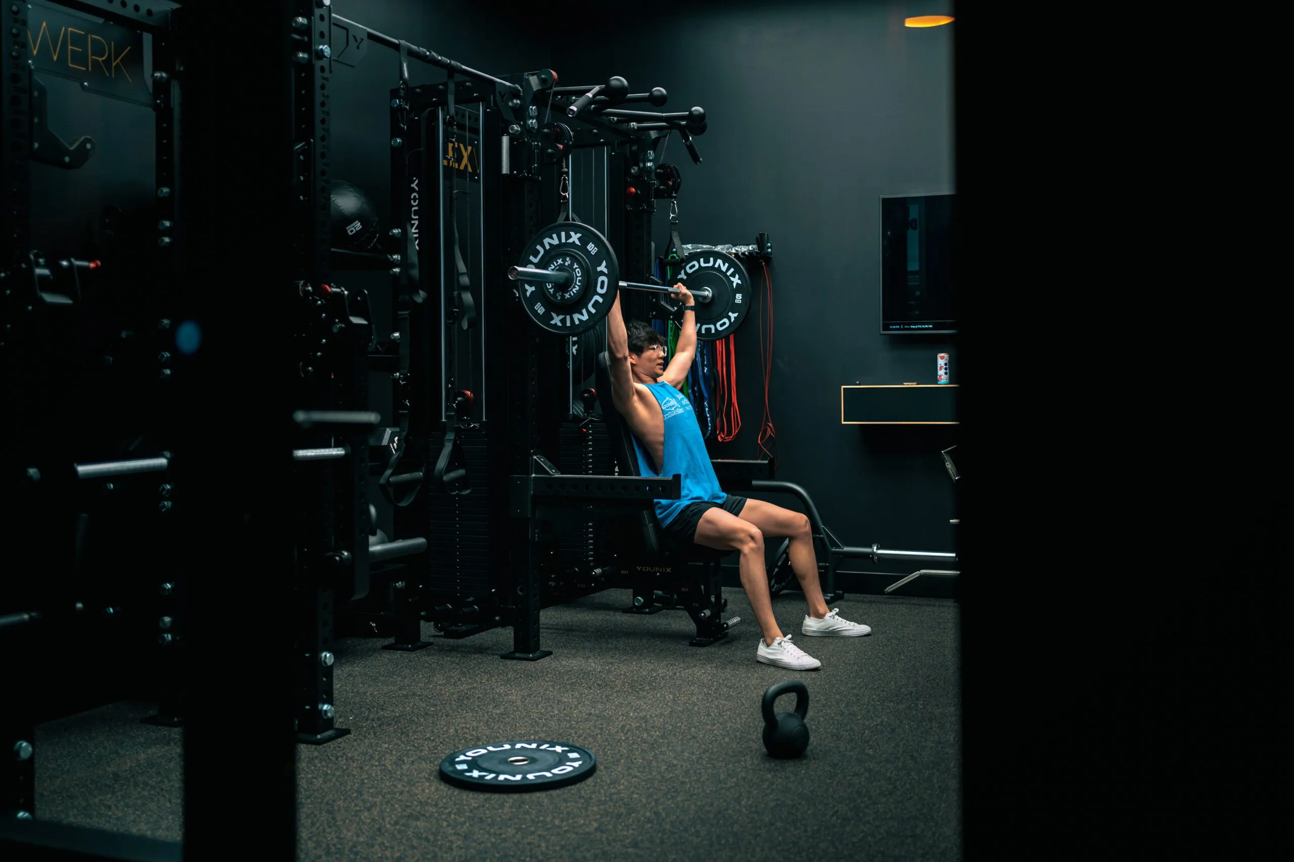 A FlexSpace Standard private space with a full rack, bench, and barbell setup